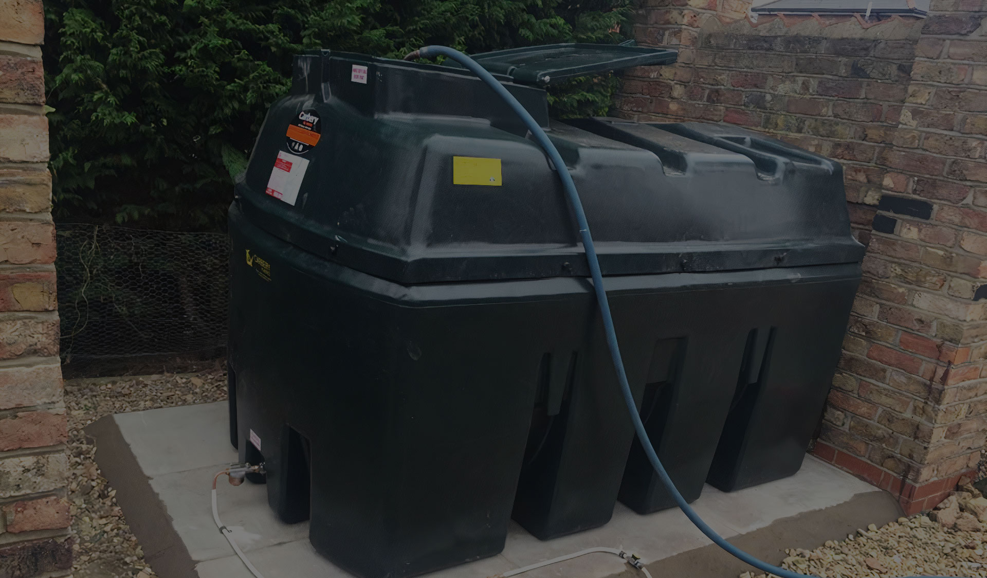 Domestic oil tanks secured beside a property